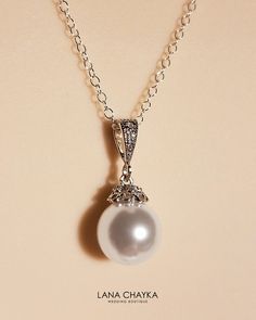 Wedding Swarovski 10mm White Pearl Drop 925 Sterling Silver Chain CZ Bridal Necklace. Classy and elegant, this necklace would be great for any wedding! CHAIN is 18 inches (45.7 cm) long. PENDANT is about 0.86 inch (2.2cm) long including bail. MATCHING EARRINGS: https://www.etsy.com/listing/99757178/bridal-white-drop-pearl-earrings?ref=shop_home_active_14 Handmade necklace, is made with .925 Sterling Silver 18 inches cable chain, Swarovski 10mm White round crystal pearl, Rhodium Sterling Silver p Wedding Jewelry With Pearl And Diamond Accents, Pearl Necklace With Diamond Accents For Wedding, Elegant Pearl Pendant Necklace For Wedding, Wedding Pearl Necklace With Diamond Accents, Elegant Pendant Pearl Necklace For Wedding, Elegant Silver Bridal Necklace For Wedding, Elegant Silver Bridal Necklace, Elegant Wedding Pearl Pendant Necklace, Elegant White Pendant Jewelry