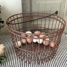 a basket filled with eggs sitting on top of a table