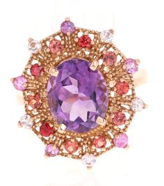 4.25 Carat Oval Cut Amethyst Sapphire Rose Gold Cocktail Ring This beautiful vintage inspired setting with a modern colorful theme has an Oval Cut Amethyst weighing 3.33 carats and is surrounded by 20 Round Cut Multi-Colored Sapphires that weigh 0.92 Carats. The total carat weight of the ring is 4.25 Carats.  The ring is made in 14 Karat Rose Gold and weighs approximately 5.5 grams.  The ring is a size 7 and complimentary ring sizing is available upon request. Multicolor Oval Amethyst Ring, Multicolor Oval Amethyst Ring With Gemstone Accents, Elegant Multicolor Amethyst Gemstone Ring, Elegant Multicolor Amethyst Ring With Gemstone Accents, Elegant Multicolor Amethyst Ring With Accent Stones, Multicolor Oval Amethyst Gemstone Ring, Luxury Multicolor Amethyst Ring For Anniversary, Multicolor Oval Amethyst Ring With Accent Stones, Luxury Multicolor Amethyst Ring For Formal Occasions