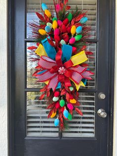 a colorful wreath is hanging on the front door