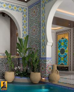 an indoor swimming pool with potted plants next to it and tile work on the walls