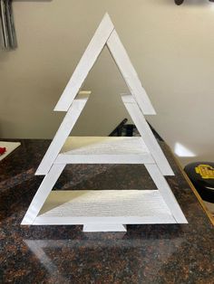 a white wooden triangle sitting on top of a counter