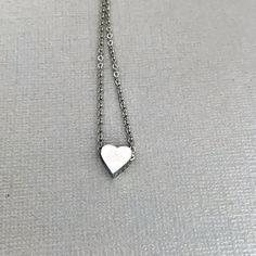 Dainty heart necklace is lightweight and perfect for everyday wear! A tiny, chunky stainless steel heart charm hangs from a fine stainless steel chain, which fastens with lobster clasp. Necklace is available in 3 lengths. Stainless steel will not tarnish, and is a great alternative for those with a sensitivity to metal! All items are carefully wrapped and packaged. In order to remain environmentally friendly, I only include a box when requested. Gift wrap is also available to purchase, and your Everyday Heart Shaped Nickel Free Necklace, Everyday Nickel Free Open Heart Necklace, Everyday Stainless Steel Jewelry With Heart Charm, Everyday Heart Charm Necklaces, Nickel Free Everyday Heart Necklace, Minimalist Stainless Steel Charm Necklace For Anniversary, Silver Charm Necklaces For Everyday And Valentine's Day, Silver Stainless Steel Heart Necklace For Gift, Everyday Stainless Steel Necklace For Mother's Day