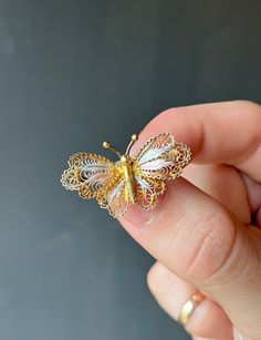 * Vintage mid-century, Norweigan handmade gold vermeil on 800 silver filigree butterfly brooch, with white and light pink highlights at the center of the wings. Finished with a C-clasp closure.  * Stamped "800" on the back of the piece  * Measurements- 1.2 inch long x 0.7 inch wide * Weight- 2.9 grams  Please view and inspect the photos closely, as they are considered part of the condition. I endeavor to fully disclose all condition information clearly, however, please note that what qualifies a Light Pink Highlights, Historical Jewellery, Pink Highlights, Butterfly Pin, Butterfly Brooch, Handmade Gold, Silver Filigree, Pin Brooch, Gold Vermeil