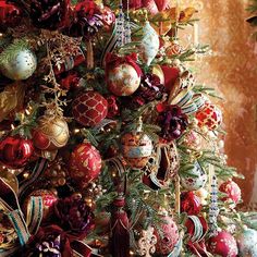 a christmas tree decorated with ornaments and ribbons