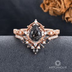 a close up view of an engagement ring with brown and white diamonds