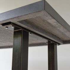 an image of a metal table top that is made out of concrete and steel beams