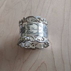 a silver ring sitting on top of a wooden table