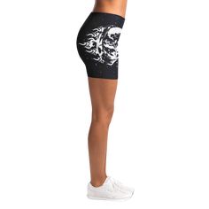 a woman wearing black and white shorts with an image of a horse on it's side