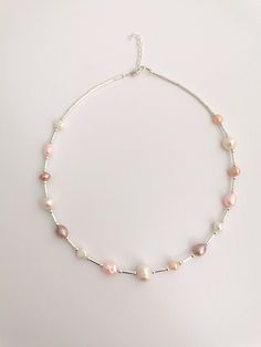 Mixed freshwater pearl necklace with natural pastel coloured pearls in various pinks and whites. Lobster claw clasp. Nickel free and hypoallergenic, perfect valentines or mother's day gift. Pearls sized between 7-12 mm . Each necklace will vary as the pearls are all different. Necklace is adjustable length 17.5-18.5 inches Feminine Pink Pearl Necklace, Delicate Pink Pearl Necklace, Pink Pearl Necklace With Pearl Pendant, Delicate Pink Pearl Pendant Necklace, Delicate Pink Pearl Necklace With Pendant, Delicate Pink Pearl Drop Necklace, Pink Necklaces With Pearl Charm And Round Beads, Pink Pearl Beaded Necklace With Pearl Charm, Handmade Pink Pearl Necklace