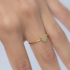 Beautiful, and dainty heart ring. ✿ Details ✿ ✤ Made of 925 Sterling Silver ✤ Available in 14k Gold or Rhodium Plated ✤ We use a THICK plating of 14k Gold for a piece that is sure to last years to come ✤ Nickel-free ✤ WILL NOT TURN FINGER GREEN! ✤ Available in Sizes 4, 5, 6, 7, 8, 9, or 10 ✤ Heart Measures 7 x 7 mm Stacking Rings Shown on Model: https://www.etsy.com/listing/739952471/dainty-diamond-stacking-eternity-ring?ref=shop_home_active_8&pro=1 https://www.etsy.com/listing/770233900/bra Dainty Gold Heart Ring For Promise, Dainty Heart Ring With Simple Design For Promise, Dainty Simple Design Heart Promise Ring, Minimalist Stackable Rings With Heart Charm For Promise, Dainty Stackable Midi Rings For Valentine's Day, Minimalist Heart Shaped Stackable Promise Rings, Dainty Stackable Heart Ring Gift, Dainty Adjustable Stackable Heart Ring, Dainty Heart Charm Stackable Gift Rings