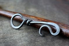 a pair of scissors sitting on top of a wooden handle