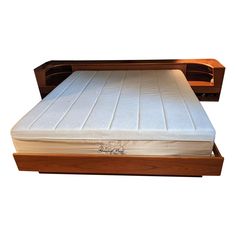 the bed frame is made from wood and has a mattress on it's side