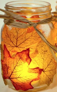 a jar filled with leaves sitting on top of a table