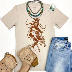 This new graphic tee is the perfect Western statement for rodeo season! It includes short sleeves, a crew neckline, and a saddle bronc graphic. Add some turquoise jewels and a hat for a fun look! Small: 4-6 Medium: 8-10 Large: 12-14 XL: 14-16 2XL: 18-20 3XL: 22-24 Fabric Content: 50% Polyester 25% Cotton 25% Rayon Care Instructions: Machine wash, cold with like colors. Only non-chlorine bleach. Tumble dry, low. Do not iron decoration. SKU: #236019 Western Short Sleeve Tops With Graphic Print, Fitted Graphic Print T-shirt For Rodeo, Western Style Relaxed Fit Graphic T-shirt, Trendy Short Sleeve Rodeo T-shirt, Saddle Bronc, Short Sleeve Graphic Print T-shirt For Rodeo, Western Graphic Tees, Cowgirl Western, Giddy Up Glamour