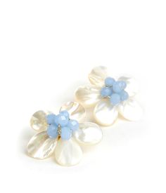 Lisi Lerch left her job on Wall Street to design timeless accessories infused with Southern charm. Crafted by hand and inspired by vintage styles, each piece reinterprets preppy fashion with a Palm Beach–chic twist. Inspired by a deep love for the beach, this lightweight mother-of-pearl flower statement stud earring adds feminine charm to any outfit. Product Details Allergy-friendly. Lead and nickel-free. Mother of pearl, gold-colored iron, and glass beaded center. Care Instructions Handle with Preppy Fashion, Golden Jubilee, Mother Of Pearl Earrings, Beach Chic, Pearl Flower, Timeless Accessories, Blue Earrings, Wall Street, Stud Earring