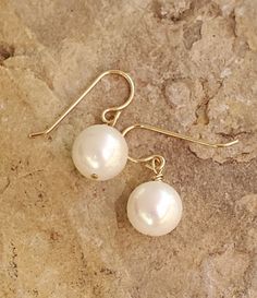 Cute dangly single white pearl earrings Pearl White Round Earrings For Everyday, Everyday Pearl White Drop Earrings, Pearl White Drop Earrings For Everyday Wear, Nickel Free Classic Dangle Pearl Earrings, Classic Nickel-free Dangle Pearl Earrings, Classic Pearl Earrings Nickel Free, Classic Handmade Pearl Earrings, Classic Nickel-free Pearl White Jewelry, Pearl White Pierced Earrings For Gift