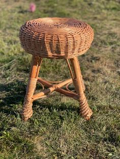 a wicker stool sitting in the grass