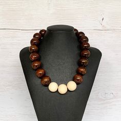 This unisex wood bead necklace was hand beaded using a mix of large 25mm round dark brown and pale oak wooden beads in a modern bohemian design. The necklace measures 19 inches long and is securely fastened with a silver clasp.  Perfect for any gender!  Length can be adjusted if needed - just ask! Wood represents a sense of earthiness, spirituality, creativity, liberty, prosperity, health, and natural touch.  Perfect for meditation, prayer, yoga practices, and everyday wear!    Check out more fa Wooden Beaded Necklace With Round Beads, Wooden Round Bead Necklaces As Gift, Wooden Round Bead Necklaces For Gifts, Wooden Round Beads Necklaces As Gifts, Wooden Round Beads Necklace As Gift, Wooden Jewelry With Large Round Beads, Brown Beaded Necklace With Large Round Beads, Brown Polished Bead Round Necklaces, Brown Round Beaded Necklace With Large Beads