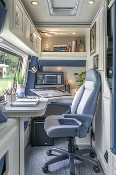 the interior of a camper with desk and chair