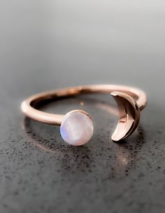 Sun and Moon Ring | Channel the power of the moon with this authentic moonstone ring. Handcrafted in 14K rose gold over sterling silver. It features an open shank sun & moon ring design and will be a wonderful addition to your ring collection. A luminous rainbow moonstone symbolizes inner growth and strength. Wear it to promote inspiration, intuition and empathy. Celestial Rose Gold Crystal Ring, Celestial Rose Gold Round Crystal Ring, Adjustable Moon Shaped Celestial Rings, Adjustable Moon-shaped Celestial Rings, Adjustable Moon-shaped Gemstone Jewelry, Adjustable Moon Shaped Gemstone Jewelry, Elegant Crescent Moon Charm Rings, Adjustable Moon Shaped Celestial Midi Rings, Adjustable Moon-shaped Celestial Midi Rings