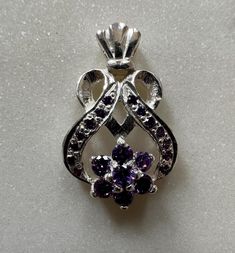 This handmade 925 sterling silver pendant is Heart shaped with Purple CZ Cubic Zircon . Pendant Height : 2.7 cm(approx) Pendant Width : 1.7 cm(approx) Pendant Weight : 4.70 grams(approx) Stone Colour : Purple Large Round Stone Center Flower Pattern  : 3mm(approx) Small Round Stone                                           :1.5mm Best Quality Guaranteed Why to wear silver? As a metal, silver has significant health benefits that have been used across cultures for centuries. Silver has a proven tra Sterling Silver White Gold Jewelry With Accent Stones, Sterling Silver Jewelry With Accent Stones In White Gold, Fine Jewelry Pendant Stamped 925, Sterling Silver Necklace With Prong Setting, Dazzling 925 Stamped Sterling Silver Jewelry, Dazzling Sterling Silver Jewelry Stamped 925, Silver Sterling Silver Necklaces With Prong Setting, Anniversary Jewelry With Stamped 925 Cubic Zirconia, Silver Necklaces With Accent Stones For Gifts