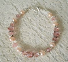 "This beautiful bracelet has freshwater pearls, pink Swarovski glass beads, sterling silver plated bead caps, sterling silver plated accent beads and seed beads. A lovely design for a wedding or special occasion. 7\" long can be adjusted to 8\". Sterling silver plated lobster clasp." Delicate Pink Bracelets For Wedding, Delicate Pink Pearl Bracelet For Wedding, Delicate Pink Bracelet For Wedding, Handmade Pink Crystal Bracelet For Wedding, Handmade Pink Crystal Elegant Bracelet, Handmade Elegant Pink Crystal Bracelet, Pink Beaded Pearl Bracelet For Wedding, Elegant Handmade Pink Crystal Bracelet, Elegant Pink Pearl Beaded Bracelets