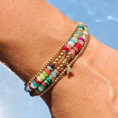 Our Gaby Beaded Bracelet is a harmonious fusion of vibrant hues and luxurious accents. This bracelet is a celebration of color, adorned with carefully selected beads that exude a lively charm. The rainbow of beads, each reflecting a different shade, creates a playful yet elegant palette that's perfect for brightening up your day. Amidst this burst of color, a delicate gold beads weaves its way, adding a touch of sophistication and warmth. Size: 7" + 2" Extension Does not include Initial Charm Multicolor Beaded Jewelry For Friendship, Hand-strung Multicolor Beaded Bangle, Hand-strung Multicolor Bracelets For Friendship, Colorful Tiny Beads Jewelry For Friendship, Multicolor Hand-strung Beaded Bangle, Multicolor Round Bead Friendship Jewelry, Multicolor Tiny Beads Bangle, Multicolor Beaded Stretch Bracelet For Friendship, Multicolor Stretch Bracelet For Friendship