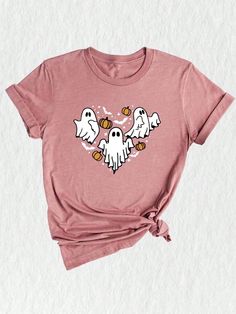 Introducing our Ghost Heart Shirt, the perfect addition to your spooky season wardrobe! This Halloween-inspired t-shirt features a captivating design that combines the ghostly elements of the season with a touch of cuteness. Get into the Halloween spirit with this Scary Ghost Shirt, which features a friendly ghost, hearts, and all the elements of a fun and memorable Halloween night. The vibrant colors and playful design make it a must-have for the Halloween party or as a Halloween gift for your Horror Themed Short Sleeve T-shirt For Fall, Spooky Cartoon Print T-shirt For Fall, Fall Spooky Cartoon Print T-shirt, Cute Halloween Tops With Funny Print, Cute Halloween Graphic Print T-shirt, Spooky Short Sleeve T-shirt For Fall, Spooky Halloween Crew Neck Top, Spooky Crew Neck Top For Halloween, Halloween Character Print Pink Top