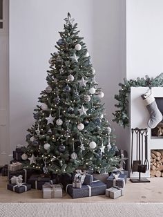 a decorated christmas tree with presents under it