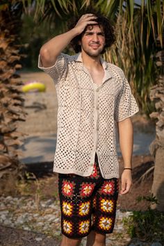 a man standing in front of some palm trees