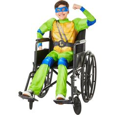 a man in a wheelchair with his arm up and wearing a turtle costume, smiling at the camera