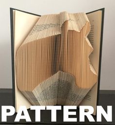 an open book with pages folded in the shape of a face and text that reads pattern