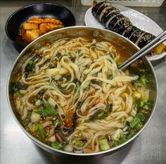 a large pot filled with noodles and vegetables