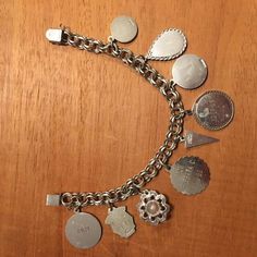 "This vintage sterling silver charm bracelet is from the 60's. It has 9 sterling silver charms including a small round disc with a cougar, Niagara Falls enameled ,expo 67 Montreal Canada, disc with engraved\"Shelly\" 12_19_65, Happy Birthday from Barbara 3-4-66, mustard seed, Debate N. F. L. 1969, Sr. High Chorus 1969. The bracelet is 7.5\" long on a double link chain with a very secure lock. This probably is a bracelet from Canada judging from the engraving. A very unique collection of charms . Vintage Engraved Charm Bracelet Gift, Silver Engraved Charms For Collectors, Collectible Silver Engraved Charms, Vintage Medallion Charms, Vintage Dangle Jewelry Stamped 925, Vintage Engraved Sterling Silver Charms, Vintage Nickel Free Silver Charms, Vintage Engraved Charm Bracelet, Engraved Sterling Silver Charm Bracelet