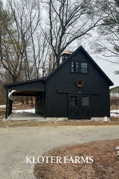 a black barn with the words kloter farms on it