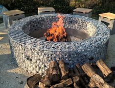 a man sitting in front of a fire pit