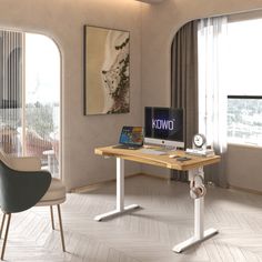 a desk with a computer on top of it in front of two chairs and a window