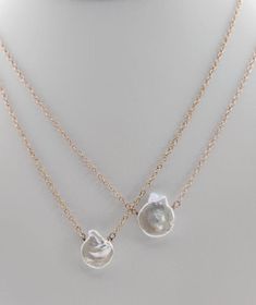 This necklace is a delicate and captivating tribute to the coastal beauty of the ocean's edge. Each Pacific Shell Necklace features meticulously chosen shells, thoughtfully arranged to create a harmonious and timeless piece of jewelry. The shells are a reflection of nature's artistry, with their unique shapes and textures mirroring the ocean's treasures. This necklace is a celebration of graceful simplicity, making it a versatile and elegant addition to your collection. Ocean-inspired Shell-shaped Mother Of Pearl Jewelry, Ocean-inspired Shell-shaped Pearl Pendant Jewelry, Shell-shaped Jewelry With Pearl Pendant, Shell-shaped Pearl Pendant Jewelry, Ocean-inspired Mother Of Pearl Jewelry With Pearl Charm, Elegant Mother Of Pearl Shell Pendant Necklace, White Pearl Necklace With Ocean-inspired Style, Ocean-inspired Shell Oyster Bracelet Jewelry, White Shell-shaped Pearl Pendant Jewelry