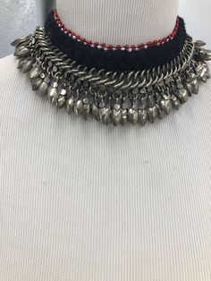 * This beautifully handcrafted silver color shade necklace is the epitome of tradition. The metallic weaving technique and dangling beads at the bottom are flaunting all the tribal vibes. The thread work at the top has complimented the whole theme of the necklace. You can pair this elegant piece of craft with any traditional or trendy outfit. Note: The product is handmade, slight change might occur in the actual product. Adjustable Antique Silver Necklace For Festivals, Silver Beaded Chain Jewelry For Festivals, Silver Jewelry With Beaded Chain For Festivals, Festive Artisan Beaded Chain Jewelry, Bohemian Silver Beaded Necklaces For Celebration, Festival Beaded Silver Necklace, Celebration Necklaces With Dangling Beads, Traditional Dangle Beaded Necklaces For Festivals, Handmade Silver Dangle Choker