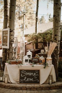 there is a table that has some food on it and candles in front of it