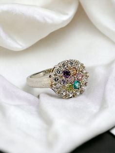 A stunning and unusual statement ring featuring a large central cluster of many bright cubic zirconia gemstones.  With its eye-catching mix of colored gemstones in multiple shapes and cuts, this substantial ring makes a bold fashion statement. This gorgeous and unique cocktail ring would be perfect for making any outfit truly stand out. Treat yourself or your loved one with this gorgeous ring! 💎🌟 🛍️ Will come packaged in a beautiful gift box 🛍️ Free shipping to the UK and USA! ✨ ✈️  ✈️  ✈️ S Multicolor Round Diamond Ring For Gift, Multicolor Round Diamond Ring Gift, Multicolor Diamond Ring As Gift, Multicolor Diamond Ring With Center Stone For Anniversary, Multicolor Diamond Ring, Fine Jewelry Multicolor Diamond Ring With Center Stone, Elegant Multicolor Cluster Ring With Accent Stones, Multicolor Elegant Cluster Ring With Accent Stones, Multicolor Cluster Ring With Accent Stones