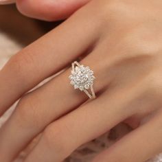 a woman's hand with a diamond ring on it