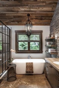 a bathroom with a tub, sink and window