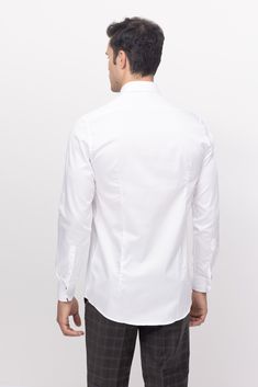 Our hidden placket shirt is tailored from pure cotton-sateen, so it's crisp and breathable. It has an immaculately tailored cutaway collar that accommodates wider ties and fastens with a silver tone tie-bar. Made with European pure cotton premium 50s single-ply sateen fabric. It is silky and refined. This high thread count makes a shirt that looks great with denim casually, or a clean suited look. Fitted construction 100% Cotton Sateen Made in Turkey Featuring rounded and cleanly stitched hems. Elegant Plain White Shirt, Elegant White Plain Shirt, Plain White Elegant Shirt, White Elegant Plain Shirt, White Plain Elegant Shirt, Slim Fit White Shirt For Office Wear, White Collared Dress Shirt For Office, White Slim Fit Shirt For Office Wear, Classic White Shirt With Lapel Collar