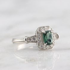 Gorgeous Vintage Inspired Tourmaline Ring ►Made of solid sterling silver with rhodium finish (925) ►Accented With Simulated Diamonds (CZ) ►Average band width: 2.3 mm ►Halo size: 9.9mm x 8.3mm Center Stone: Tourmaline Shape: Emerald Measurements: 4.0 x 6.0 mm Carat Weight: 0.7 ct. (approx.) Gemstone creation: 100% Natural Hardness: 7-7.5 (Mohs scale) ✓ 100% Nickel-Free ✓ Hypoallergenic ✓ Comfort Fit ✓ Free Ring Box ✓ Free USA Shipping *All listing photos are subject to copyright. *All rights rese Classic May Birthstone Ring With Accent Stones, Classic Jewelry With Halo Setting For May Birthstone, Heirloom Ring With May Birthstone Center Stone, Heirloom Ring With Center Stone For May Birthstone, Classic Halo Setting Jewelry For May Birthstone, Classic Cluster Ring With May Birthstone Gemstone, Classic Promise Crystal Ring With Gemstone, Classic Crystal Ring With Accent Stones For Promise, Classic Sapphire Ring For May Birthstone Gift