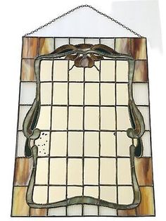 a stained glass mirror hanging on the wall