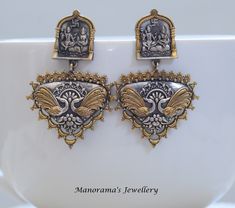 Beautiful two tone chand baali earrings!! Totally cool, royal and chic! Post of the earrings has Shiva Parvathi motifs. Statement Earrings. Earring measure 2 1/4 inches (6 cm) in length. These earrings are made of copper brass alloy and have an antique finish to them! JEWELERY CARE INSTRUCTIONS Please make sure that these items must be treated with care and stored properly. Jewelry should not be worn while sleeping or exposed to water while bathing or swimming. Perfumes and hairspray can damage Festive Dual-tone Earrings For Puja, Dual-tone Temple Jewelry Earrings For Puja, Bollywood Style Danglers With Intricate Design For Puja, Intricate Design Danglers For Puja And Festivals, Bollywood Danglers With Intricate Design For Puja, Dual-tone Earrings For Puja And Festivals, Ceremonial Temple Jewelry Danglers For Festivals, Traditional Dual-tone Earrings For Diwali, Chandbali Peacock Earrings For Puja