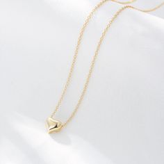 A gleaming heart of 18-karat gold anchors this chain necklace that makes a meaningful gift for a loved one. Hand-crafted using 18K gold plated sterling silver. - Care Instructions: Avoid contact with water, lotion, and perfume. Clean gently with a polishing cloth. Product Specifications: - 18K gold plating over .925 Sterling Silver - Hypoallergenic - Cubic Zirconia crystals Elegant Heart Necklace Tarnish Resistant As Gift, Yellow Gold Chain Necklace For Valentine's Day, Valentine's Day Yellow Gold Chain Necklace, Elegant Heart Shaped Gold Chain Necklace, Elegant Heart-shaped Gold Chain Necklace, Elegant Heart Pendant Charm Necklace On Gold Chain, Elegant Charm Necklace With Heart Pendant And Gold Chain, Elegant Heart Pendant Charm Necklace With Gold Chain, Elegant Gold Chain Charm Necklace With Heart Pendant