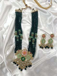 Green Beaded set with oversized design and matching earrings. The matching earrings are also beautiful and bold to go along with the necklace. This is an adjustable necklace and can be adjusted to obtain the desired length across the neckline. The colors really brighten the look and are able to go with any outfit! Chandbali Tilla Beaded Necklaces For Festivals, Heavy Beaded Temple Jewelry Necklaces For Festive Occasions, Festive Temple Jewelry Chandbali Beaded Necklaces, Heavy Beaded Necklaces For Festive Occasions, Heavy Beaded Necklaces For Festive Occasions And Festivals, Temple Jewelry Kundan Beaded Necklace With Latkans, Festival Kundan Beaded Necklaces With Latkans, Green Heavy Necklace For Navratri, Heavy Green Necklaces For Navratri